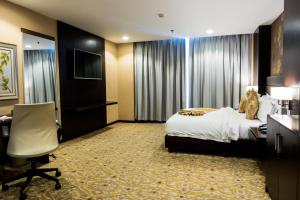 Postel nebo postele na pokoji v ubytování Marcian Garden Hotel