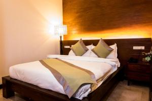 Postel nebo postele na pokoji v ubytování Marcian Garden Hotel