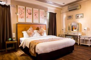Postel nebo postele na pokoji v ubytování Marcian Garden Hotel