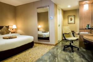 Postel nebo postele na pokoji v ubytování Marcian Garden Hotel
