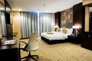 Postel nebo postele na pokoji v ubytování Marcian Garden Hotel