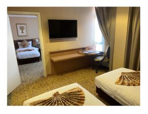 Postel nebo postele na pokoji v ubytování Marcian Garden Hotel