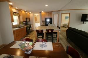 a kitchen and living room with a table and chairs at Island Club #77 in Put-in-Bay