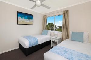 A bed or beds in a room at Dockside Apartments Mooloolaba