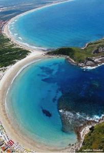 an aerial view of a beach with blue water at Perohouse in Cabo Frio
