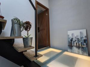 a room with a mirror and a potted plant at 阡陌-頂加民宿 in Tainan