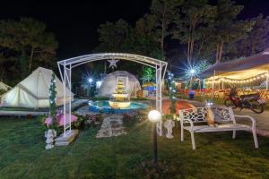 a group of tents and a fountain at night at Ozone by บ้านเขาค้อ in Phetchabun