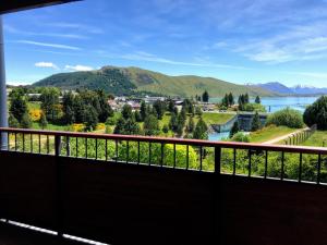 a balcony with a view of a river and mountains at TekapoB2 Lakeview Apartment in Lake Tekapo