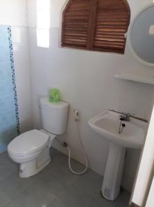 a bathroom with a toilet and a sink at Lovely Farm in Khao Kho