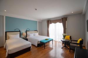 Postel nebo postele na pokoji v ubytování Hoian Sincerity Hotel & Spa + 37 fotografií