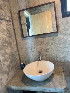 a bathroom with a white sink and a mirror at Somphoch Garden in Trat