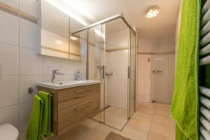 a bathroom with a sink and a shower at Chalet Ramona in Grächen