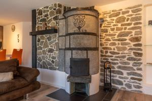a fireplace in a living room with a stone wall at Chalet Ramona in Grächen