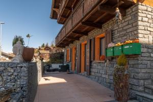 a stone building with a walkway in front of it at Chalet Ramona in Grächen