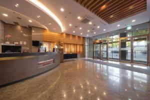 an empty lobby with a reception desk and glass doors at Ramada by Wyndham Seoul Dongdaemun in Seoul