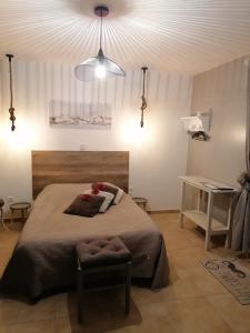 a bedroom with a large bed and a ceiling at Chambre d'hotes Le Hamel in Le Hamel