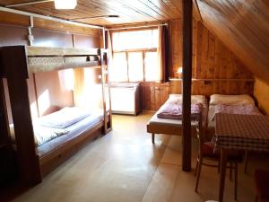 a room with two bunk beds in a cabin at Horská chata U Pekařů in Pec pod Sněžkou