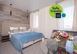 a bedroom with a bed and a table with flowers at Mix Hotels Nevsky 67 in Saint Petersburg