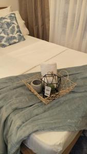 a basket of towels and towels on a bed at La Suerte Condo at SMDC Tagaytay in Tagaytay