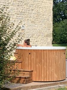 a woman taking a bath in a bath tub at Manoir de Cléronde - B&B in Blay