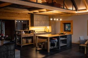 a kitchen with wooden cabinets and a wooden table at Chalet SALAMANDRA in Banská Štiavnica