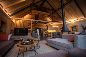 a living room with a couch and a tv and a table at Chalet SALAMANDRA in Banská Štiavnica