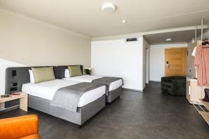 Ένα ή περισσότερα κρεβάτια σε δωμάτιο στο Cavalieri Art Hotel