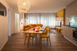 a kitchen and dining room with a table and chairs at GAMA Home in Fribourg