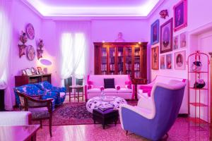 a living room with pink and blue chairs and a table at Casa Bertagni in Bologna
