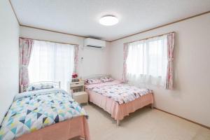 Postel nebo postele na pokoji v ubytování Travel Palace Miyuki