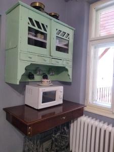 a microwave sitting on top of a table next to a window at Domcek Miriam in Hrabušice