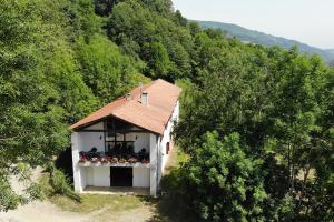 ein kleines weißes Gebäude mit einem Dach auf einem Hügel in der Unterkunft Casa Rural Toki Ona II in Valcarlos