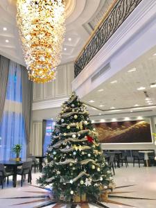 a christmas tree in a room with a piano at Tuong Vi Corner in Ho Chi Minh City