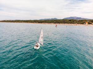 a sailboat sailing on a body of water at Resort Riva Degli Etruschi in San Vincenzo