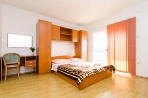 Postel nebo postele na pokoji v ubytování Apartmani Popović