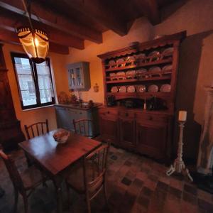 a kitchen with a wooden table and a dining room at Die Kleine Auszeit in Wadern +22 photos
