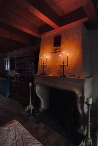 a living room with a fireplace with candles on it at Die Kleine Auszeit in Wadern