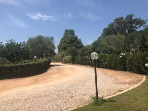 a dirt road with two street lights on it at White Sand Residence in Murta Maria