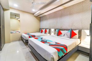 a bedroom with two beds in a room at FabHotel Grand Heritage Kurla West in Mumbai