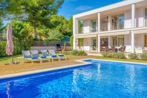 a villa with a swimming pool and a house at Casa Suca in Santa Ponsa