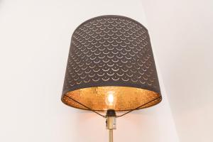 a lamp with a black shade on a wall at The Ring Suites in Graz