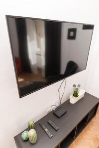 a flat screen tv hanging on a wall above a table at The Ring Suites in Graz