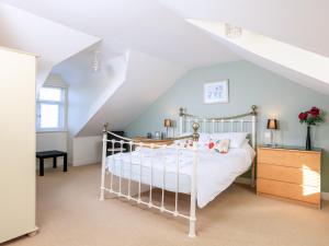 a bedroom with a white bed in a attic at 2 The Bay in Kingsbridge