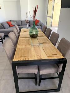 a wooden table with chairs and a vase on top at Apartamento Benidorm II in Benidorm