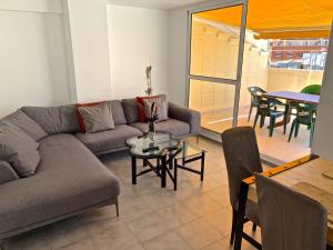 een woonkamer met een bank en een tafel bij Apartamento Benidorm II in Benidorm