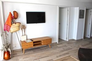 uma sala de estar com uma televisão na parede em Apartamento Cabo Azul em El Campello