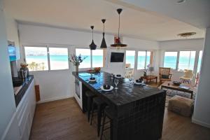 a kitchen with a large island in a room with the ocean at Apartamento Vista Azul in El Campello