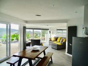 a living room with a table and a couch at The Kite, Upper Torrs View in Ilfracombe