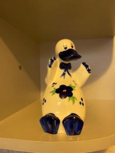 a ceramic duck statue sitting on top of a shelf at Домашний уют in Karagandy