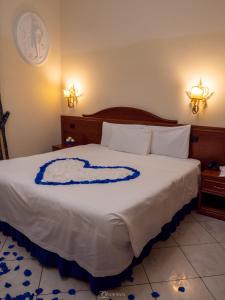 a bedroom with a bed with a blue and white blanket at Caroline Suite in Rome